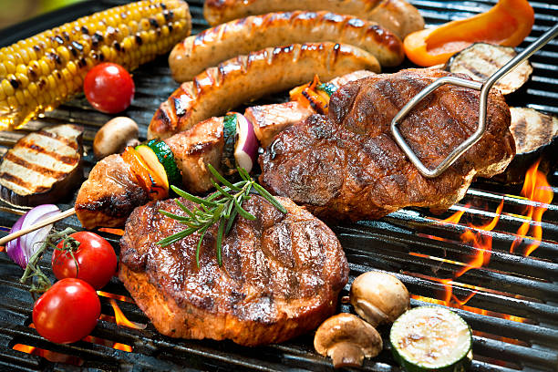 Assorted delicious grilled meat with vegetable over the coals on a barbecue